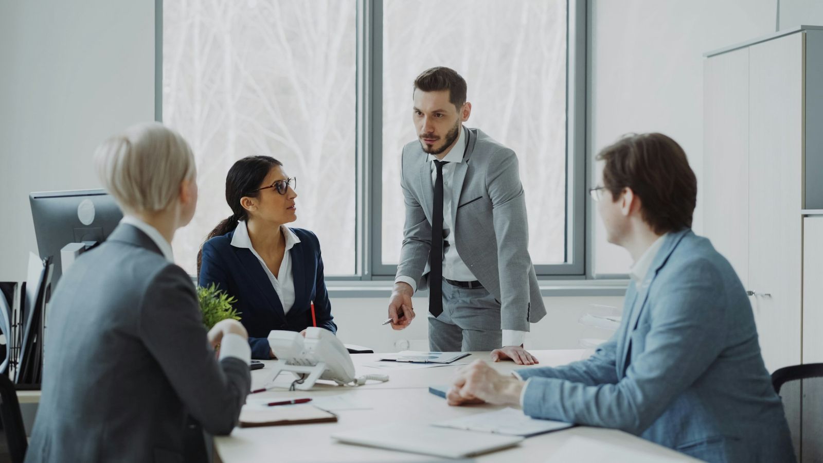 Business owners reviewing reports together around a boardroom table