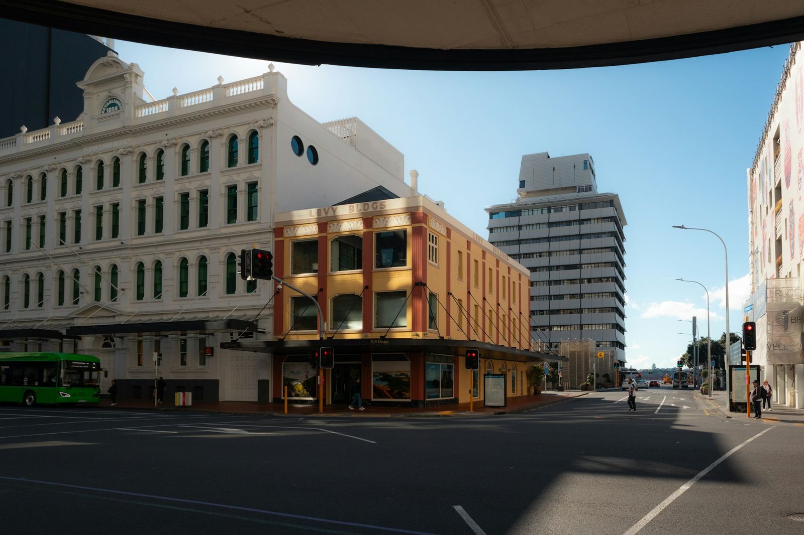 Heritage commercial buildings on an Auckland street corner under a clear blue sky