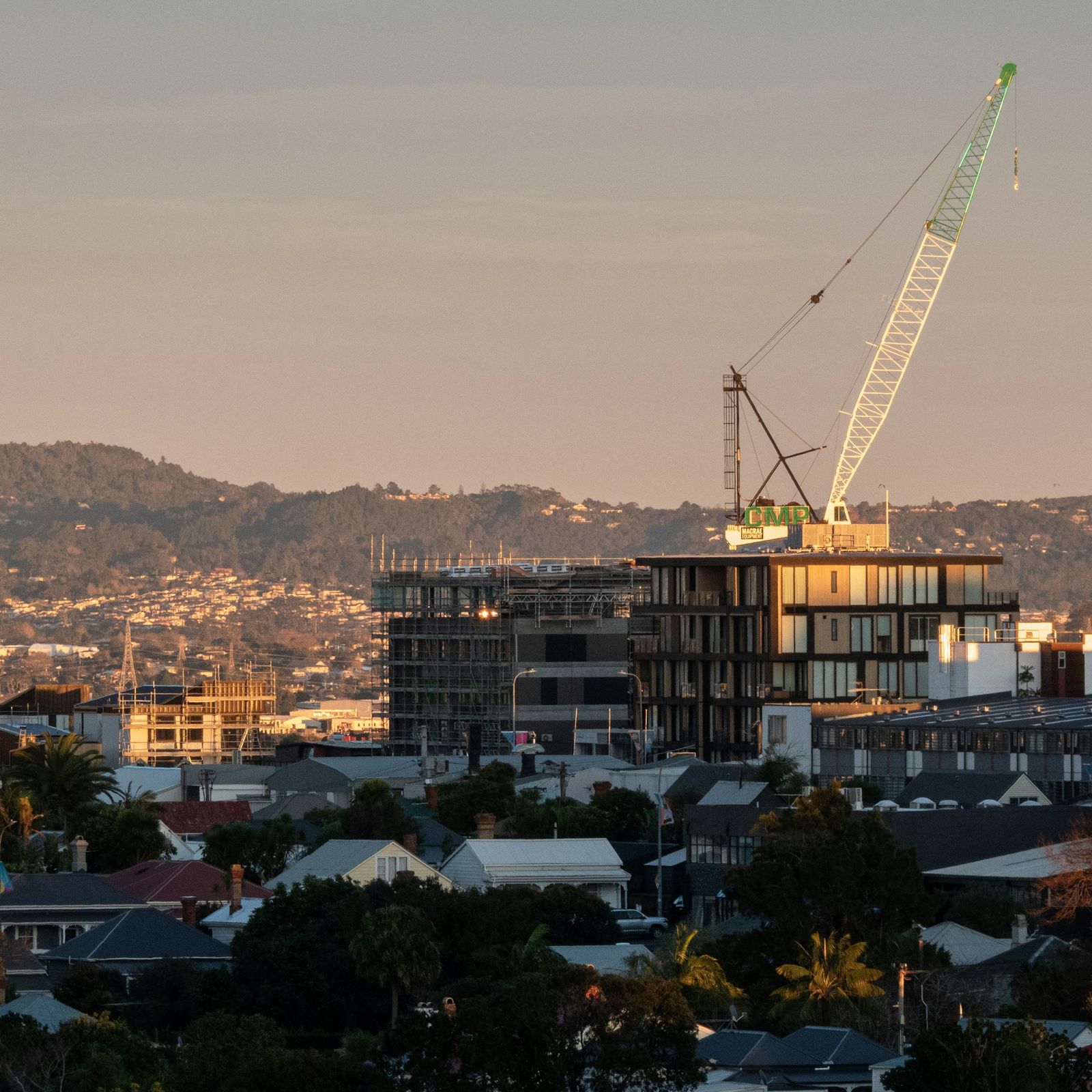 Construction crane above a new apartment building in Grey Lynn, Auckland, at sunrise